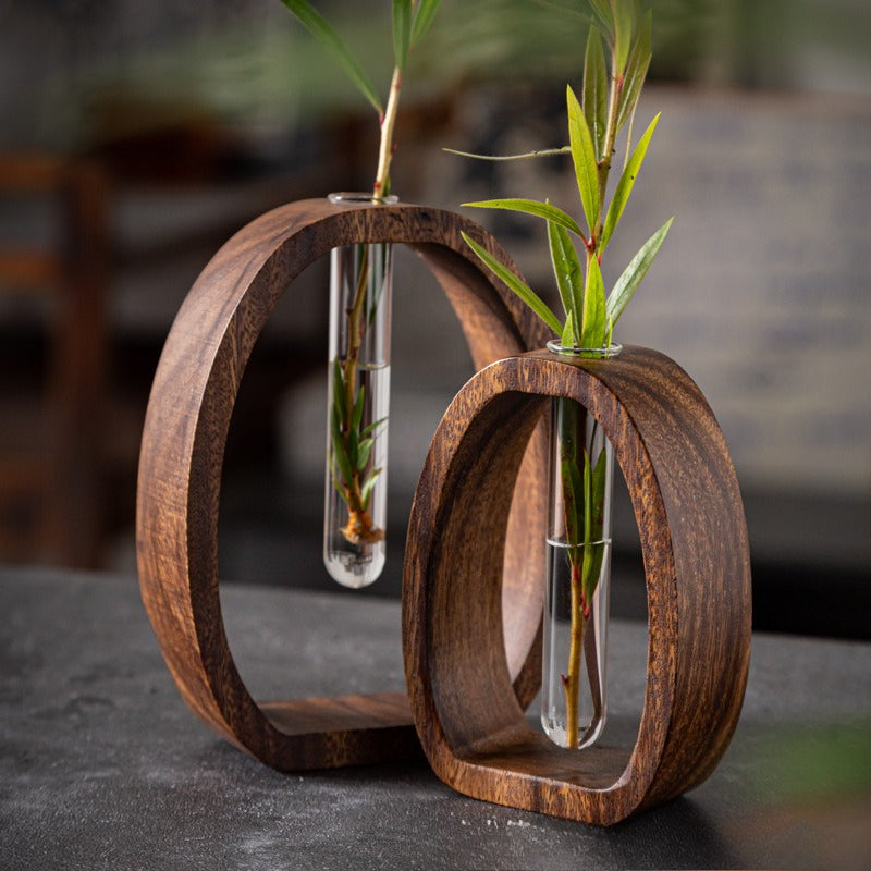 This Set of Four Hydroponic Plant Holders Made from Walnut Wood Features Two Round Geometric Bases And Two Glass Vases, Along with a Stylish Glass Flower Vessel for Desktop Use, Enhancing The Decor of Both Home And Office Environments